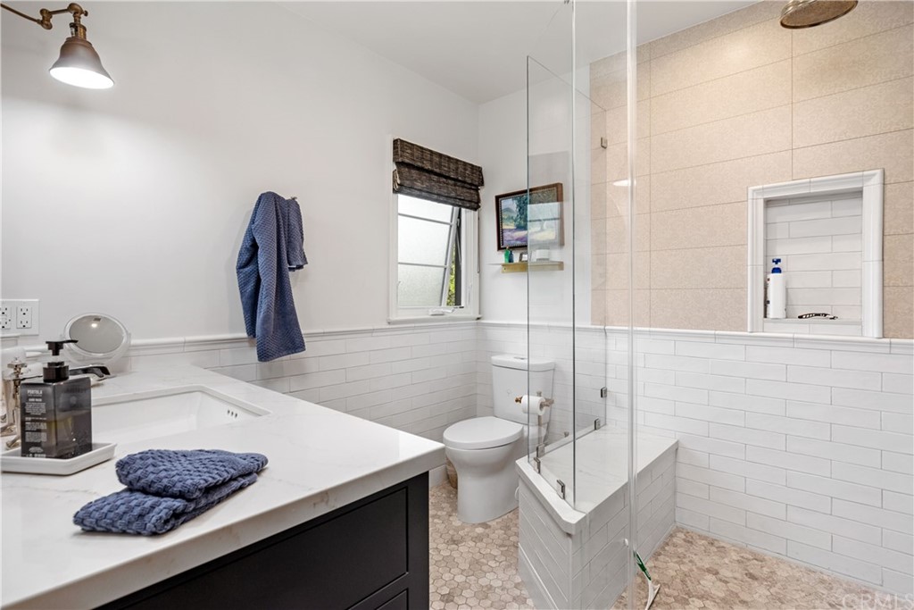 351 Whiting Street El Segundo, CA 90245 - Photo 22 of 60 a bathroom with a sink a toilet and mirror
