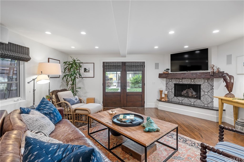 351 Whiting Street El Segundo, CA 90245 - Photo 27 of 60 a living room with furniture a flat screen tv and a fireplace