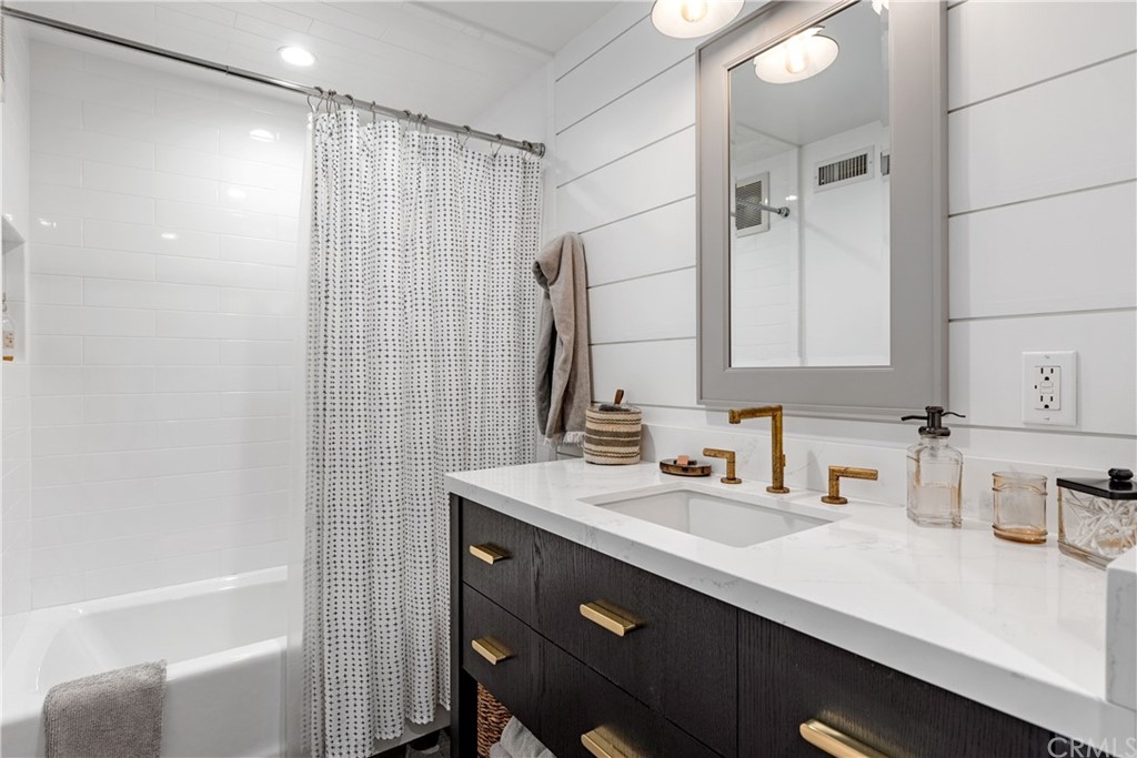 351 Whiting Street El Segundo, CA 90245 - Photo 33 of 60 a bathroom with a sink a mirror and a bathtub