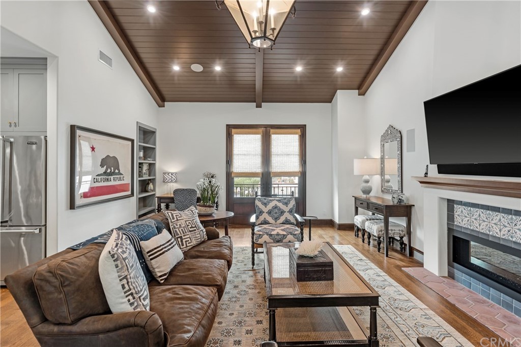 351 Whiting Street El Segundo, CA 90245 - Photo 49 of 60 a living room with furniture a flat screen tv and a fireplace