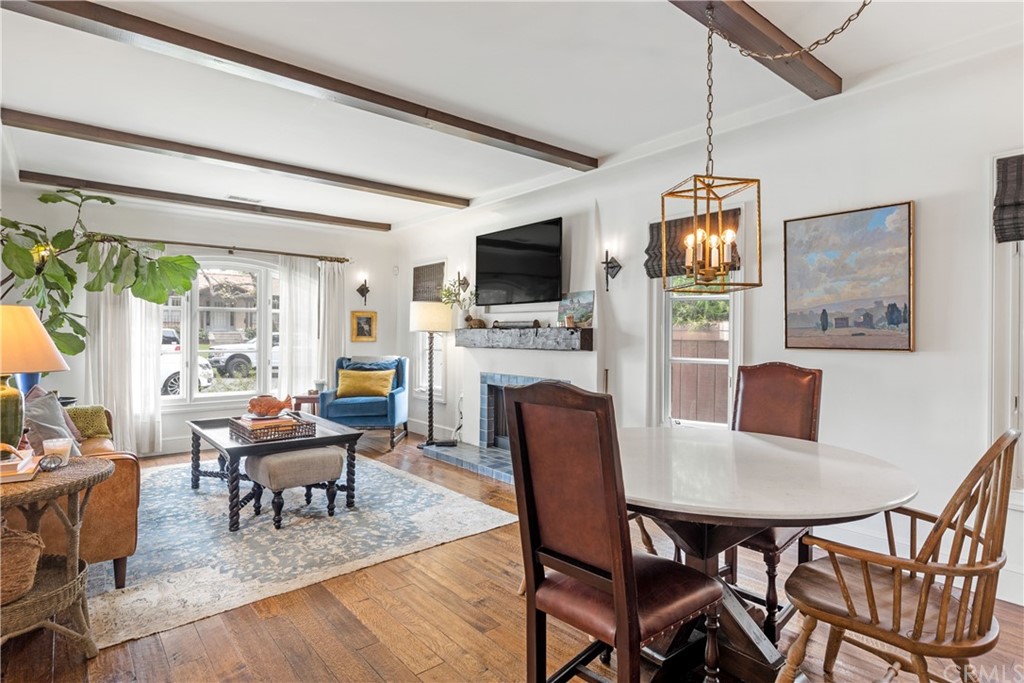 351 Whiting Street El Segundo, CA 90245 - Photo 8 of 60 a living room with dining table a flat screen tv and a large window