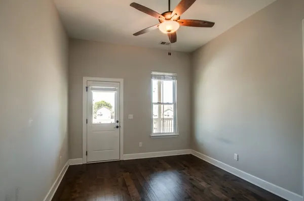 wooden floor in an empty room with a window