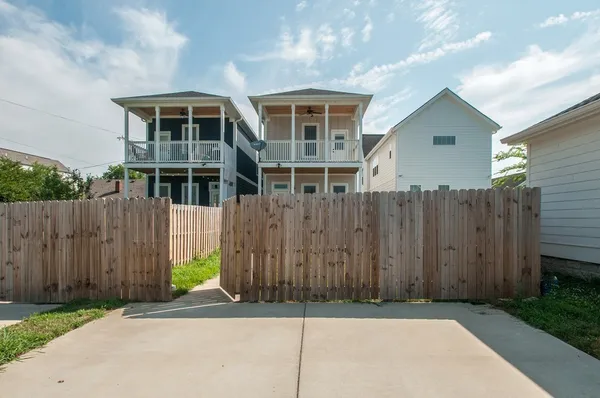 a view of a house with wooden fence