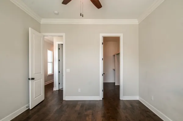an empty room with wooden floor and closet