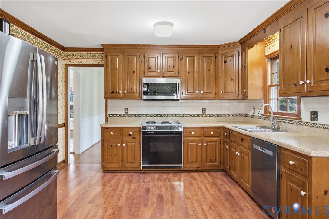 12918 Ashtree Road Midlothian, VA 23114 - Photo 11 of 43 a kitchen with stainless steel appliances granite countertop a stove sink and refrigerator