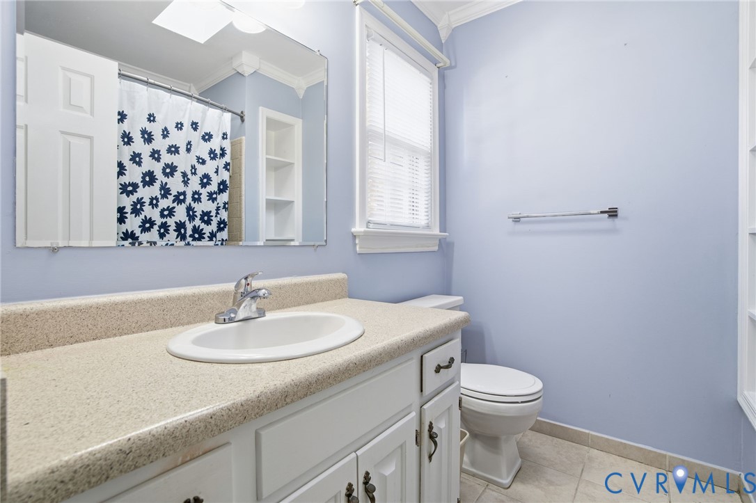 12918 Ashtree Road Midlothian, VA 23114 - Photo 19 of 43 a bathroom with a sink a toilet and shower curtain