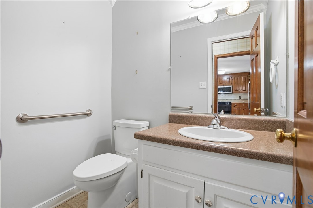 12918 Ashtree Road Midlothian, VA 23114 - Photo 28 of 43 a bathroom with a granite countertop sink mirror vanity and toilet