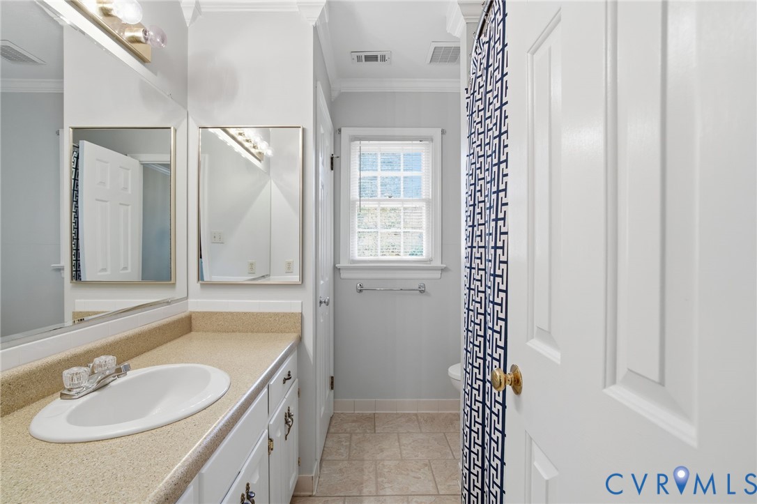 12918 Ashtree Road Midlothian, VA 23114 - Photo 29 of 43 a bathroom with a sink a mirror and a shower