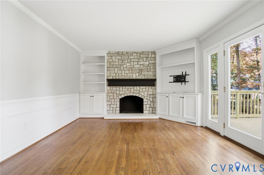 12918 Ashtree Road Midlothian, VA 23114 - Photo 8 of 43 a view of a livingroom with wooden floor a fireplace and windows