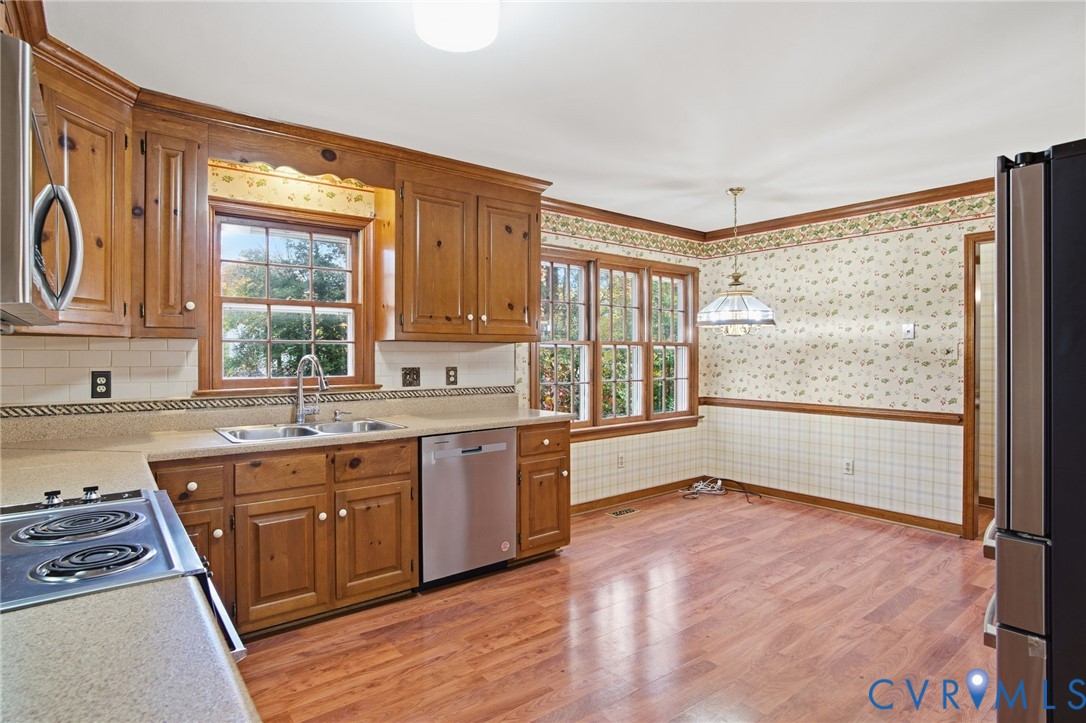 12918 Ashtree Road Midlothian, VA 23114 - Photo 10 of 43 a large kitchen with stainless steel appliances granite countertop wooden cabinets a sink and a large window