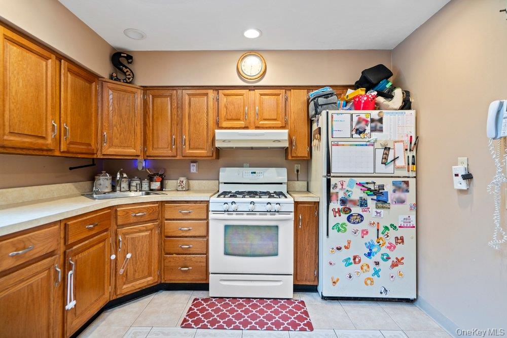 101 Sexton Road West Babylon, NY 11704 - Photo 14 of 33 a kitchen with refrigerator and cabinets