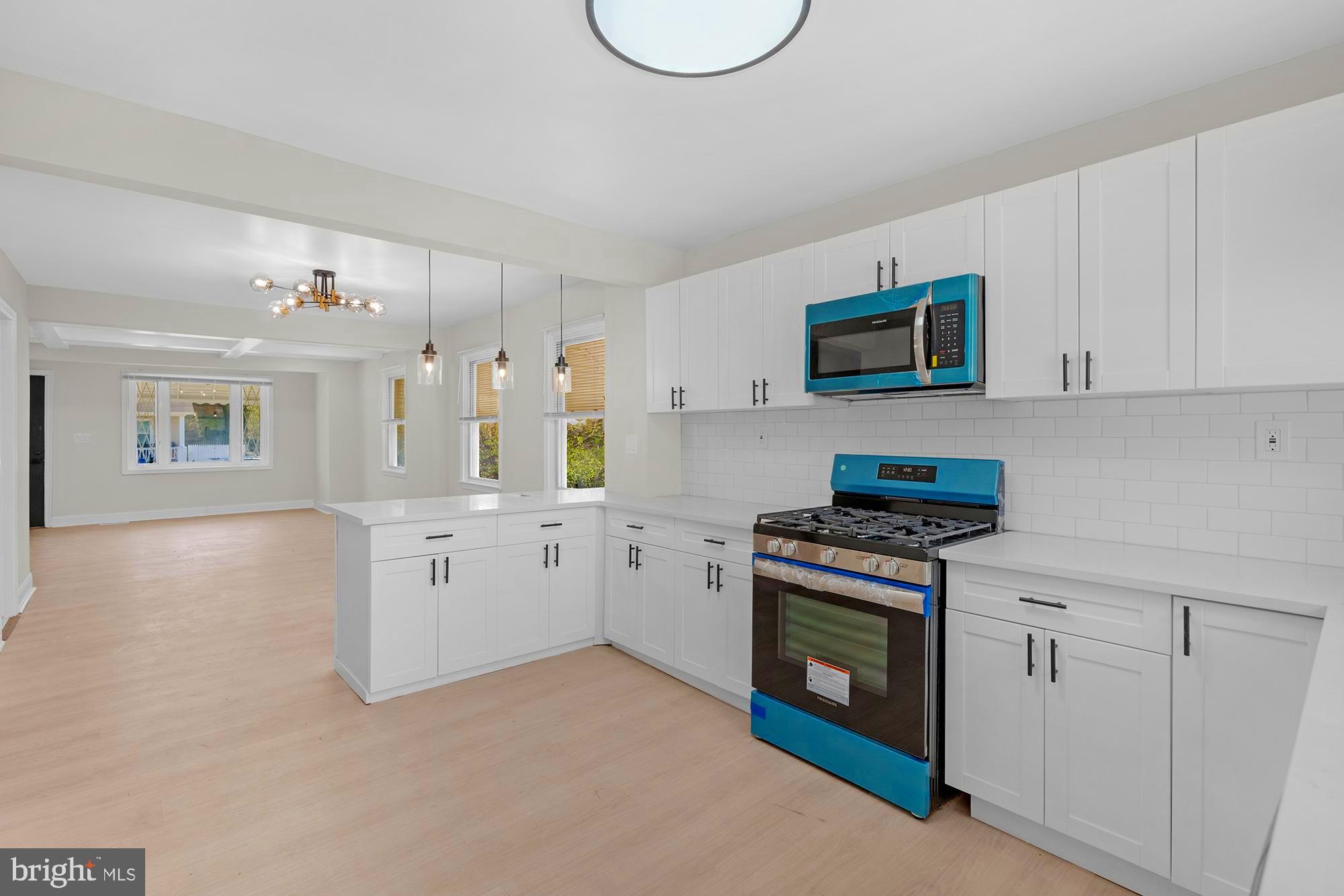 3708 West Cold Spring Lane Baltimore, MD 21215 - Photo 12 of 33 a kitchen with white cabinets and a stove top oven