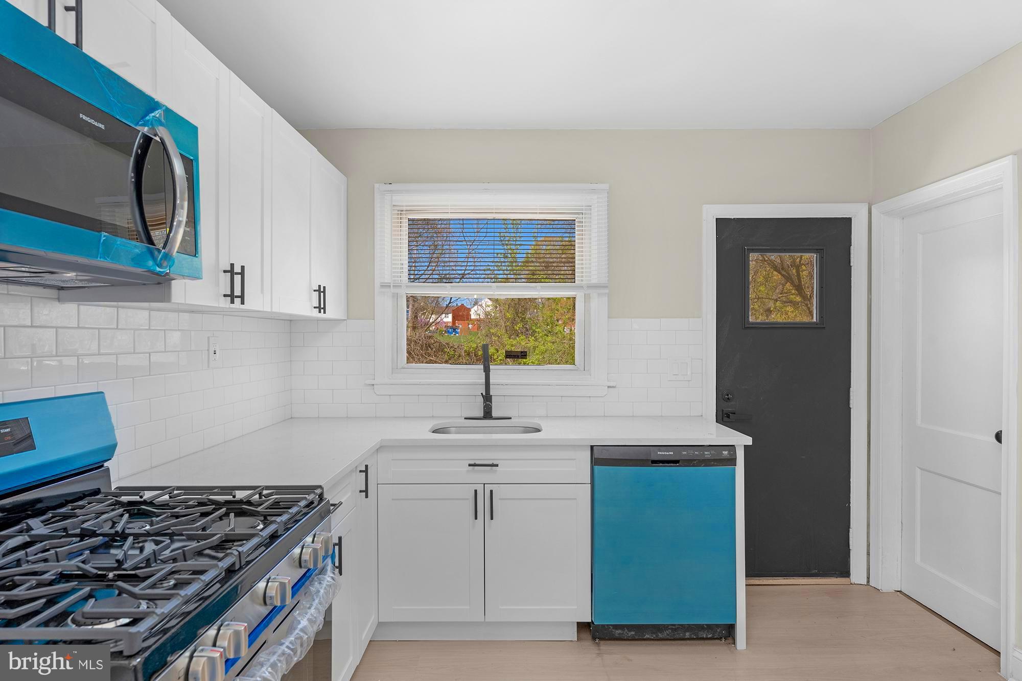 3708 West Cold Spring Lane Baltimore, MD 21215 - Photo 13 of 33 a kitchen with a sink stove and cabinets