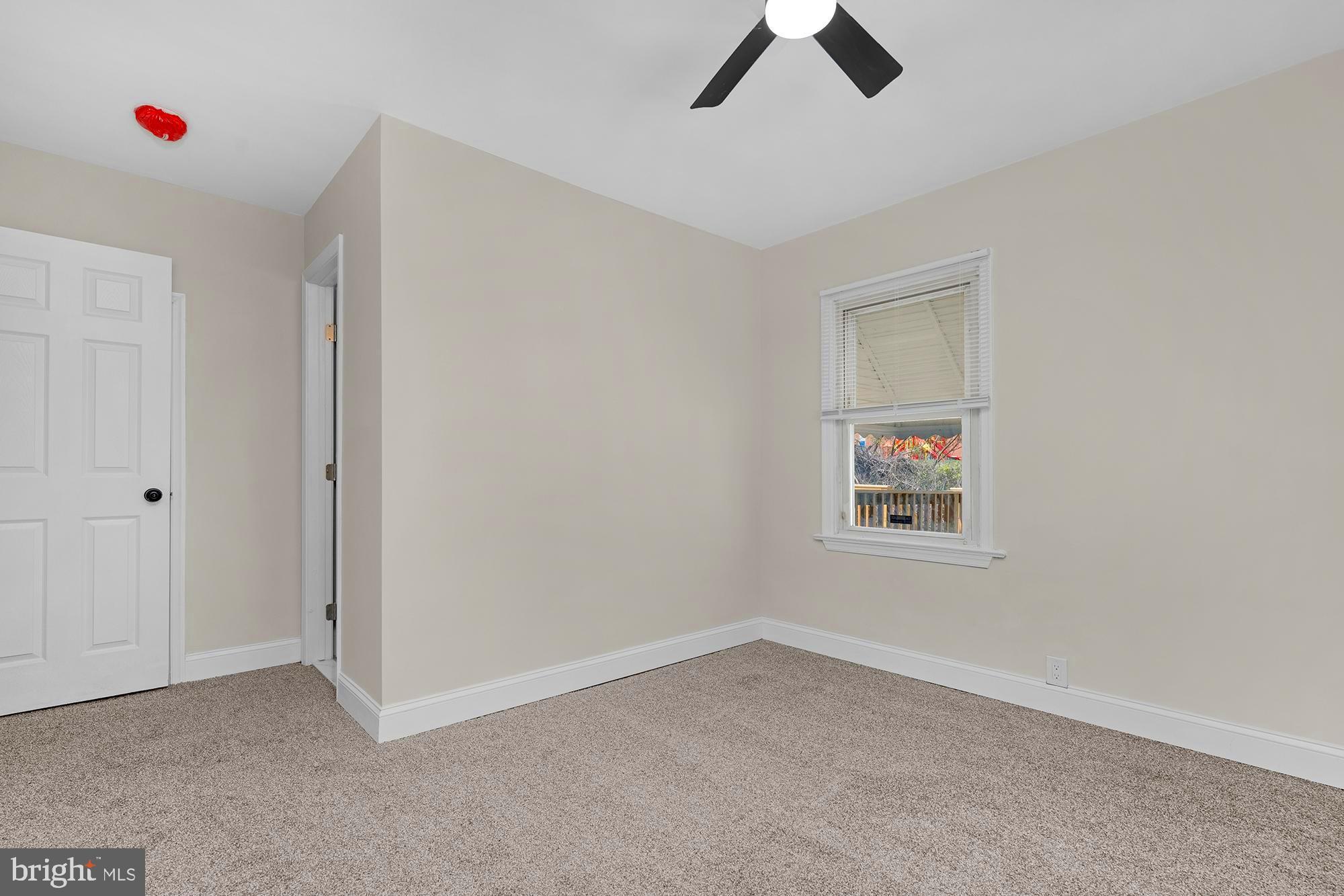 3708 West Cold Spring Lane Baltimore, MD 21215 - Photo 17 of 33 an empty room with ceiling fan and window