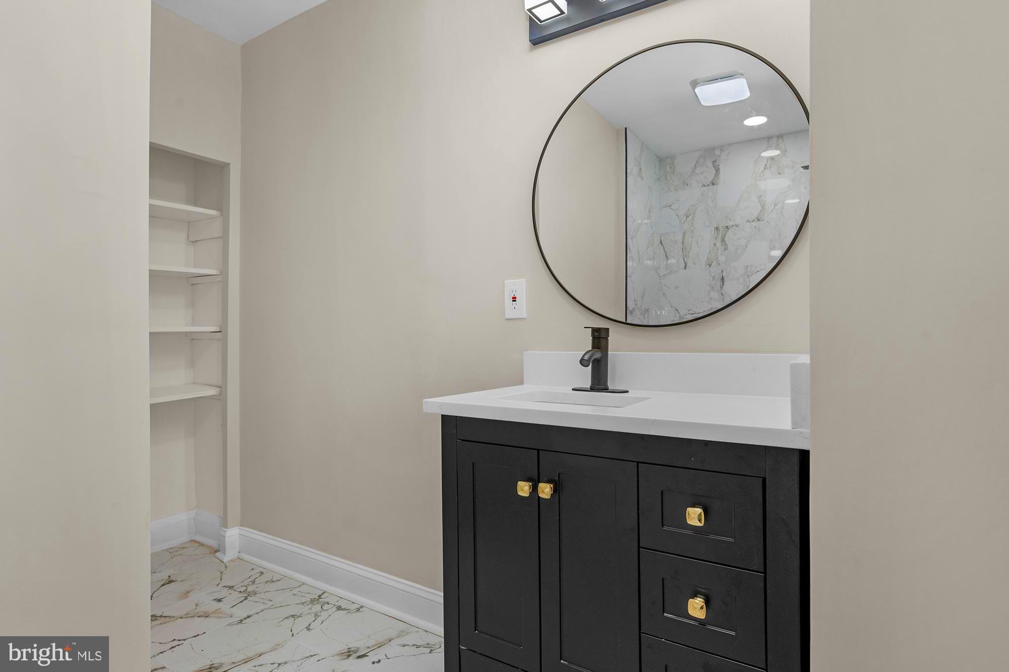 3708 West Cold Spring Lane Baltimore, MD 21215 - Photo 21 of 33 a bathroom with a sink and a mirror