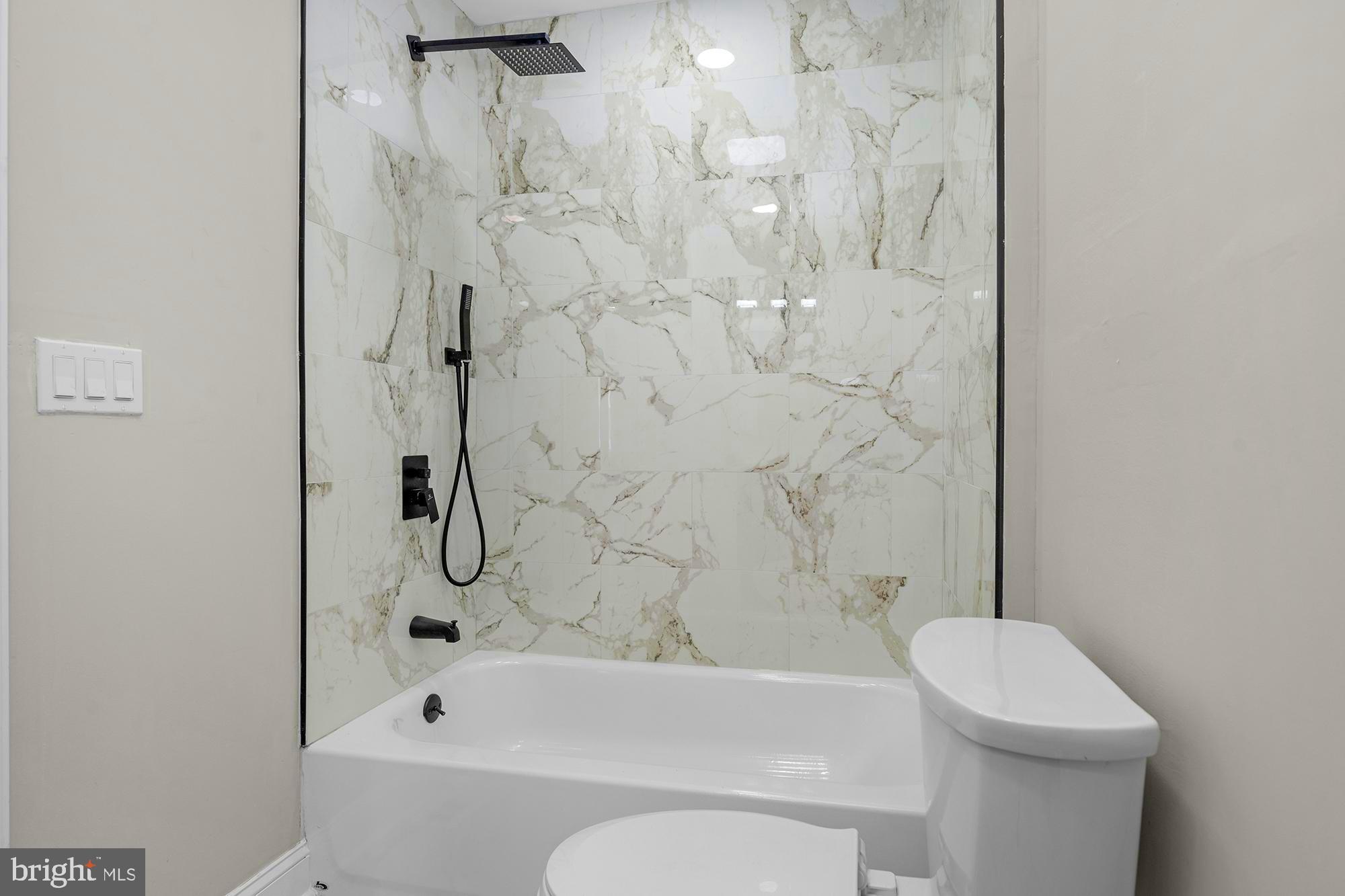 3708 West Cold Spring Lane Baltimore, MD 21215 - Photo 22 of 33 a bathroom with a bathtub and a toilet