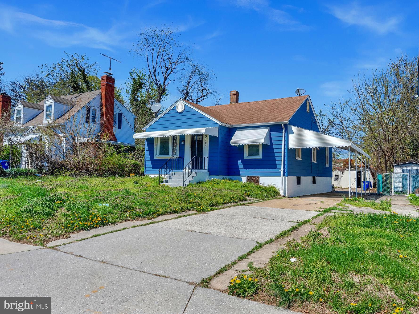 3708 West Cold Spring Lane Baltimore, MD 21215 - Photo 31 of 33 a front view of a house with a yard
