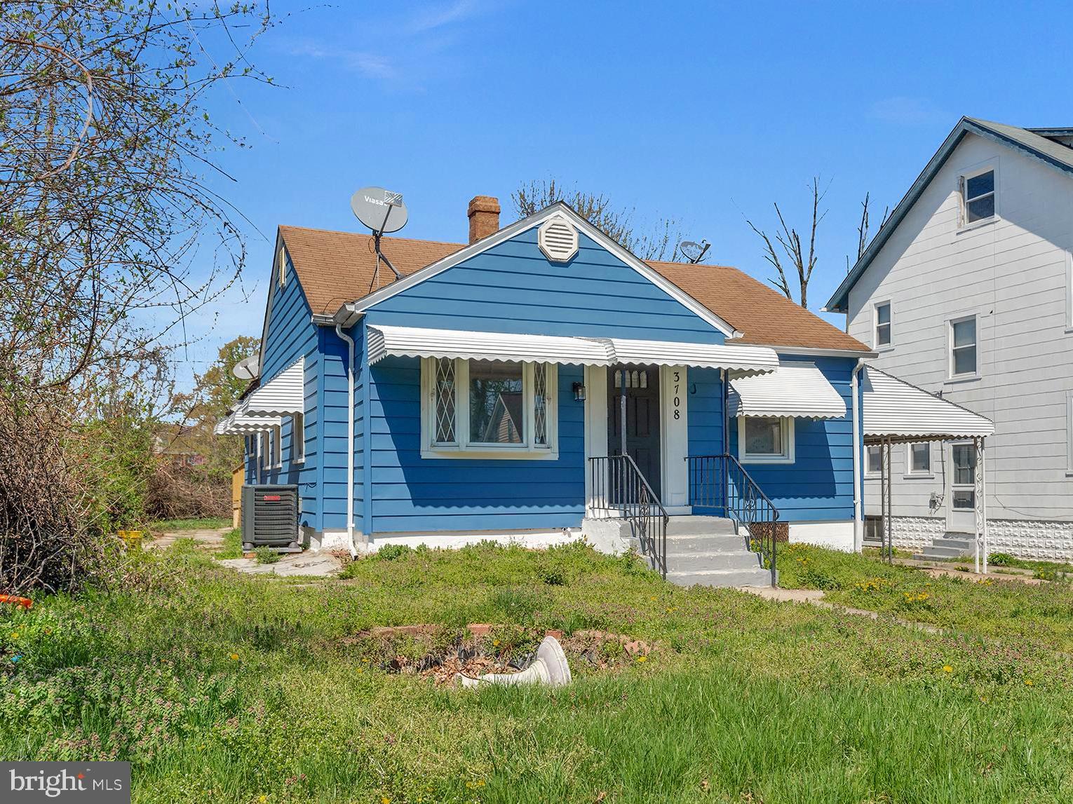 3708 West Cold Spring Lane Baltimore, MD 21215 - Photo 32 of 33 a front view of a house with a yard