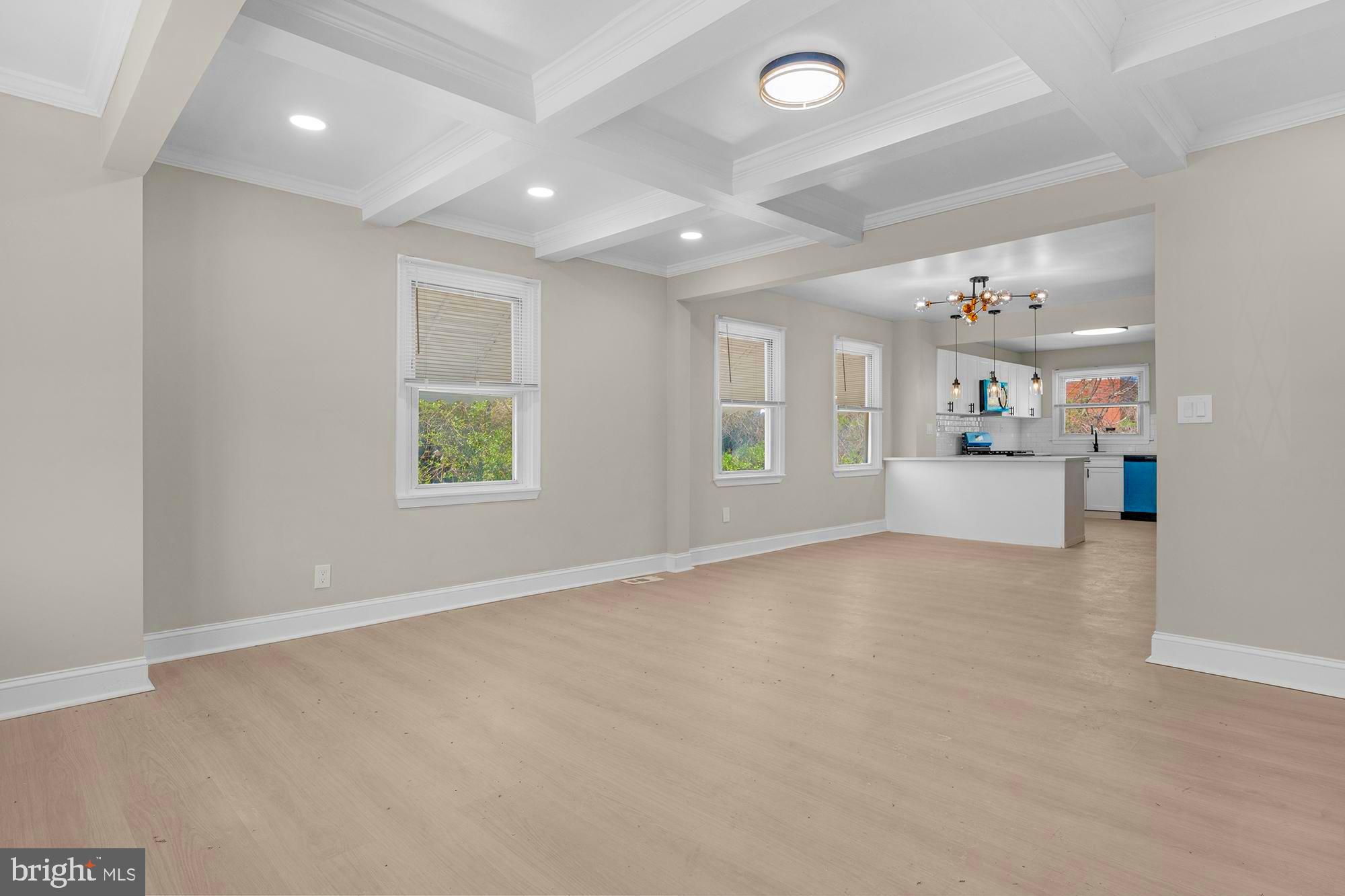 3708 West Cold Spring Lane Baltimore, MD 21215 - Photo 7 of 33 an empty room with windows and couches