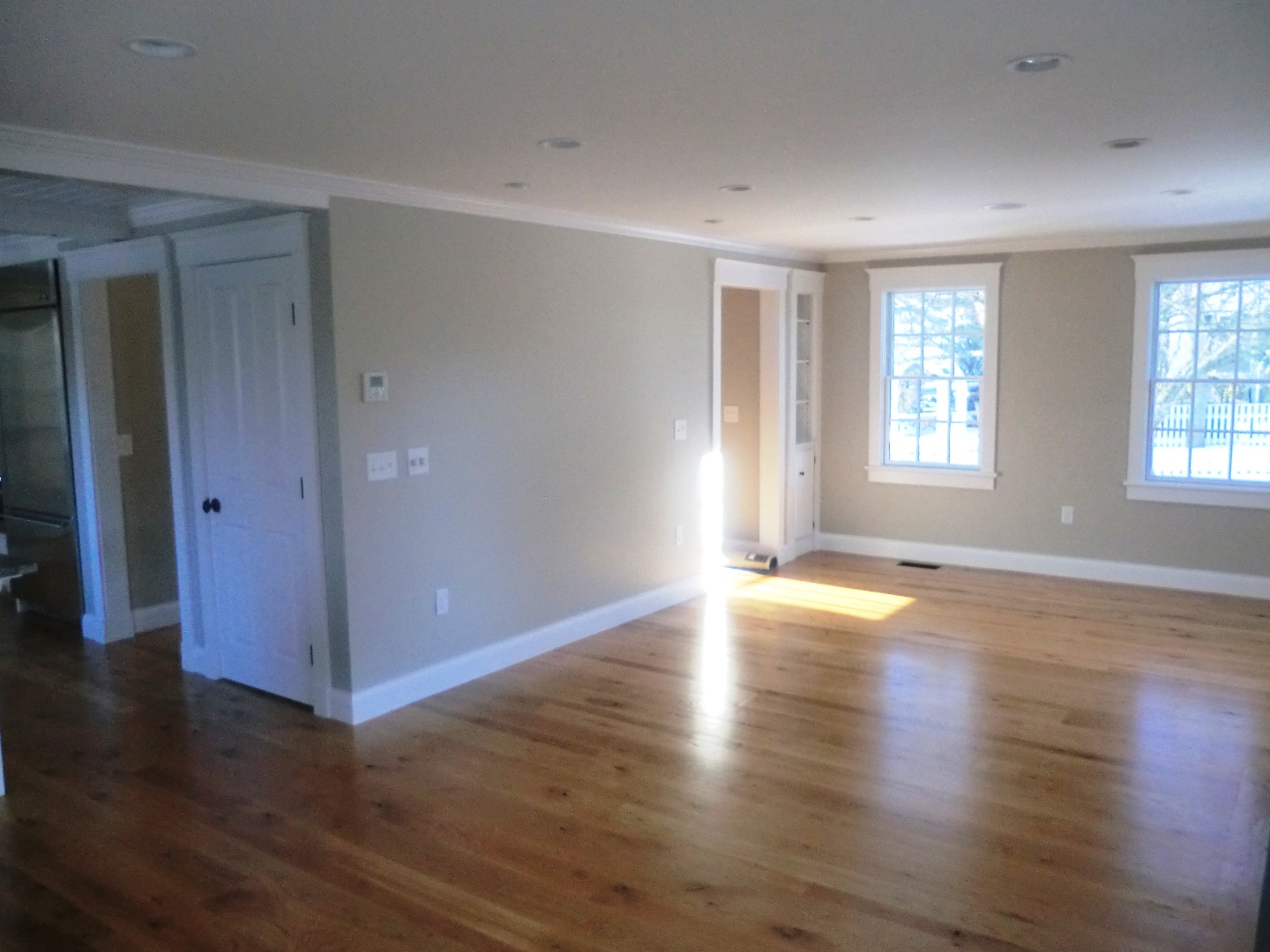 114 South Summer Street Edgartown, MA 02539 - Photo 14 of 102 an empty room with wooden floor and windows