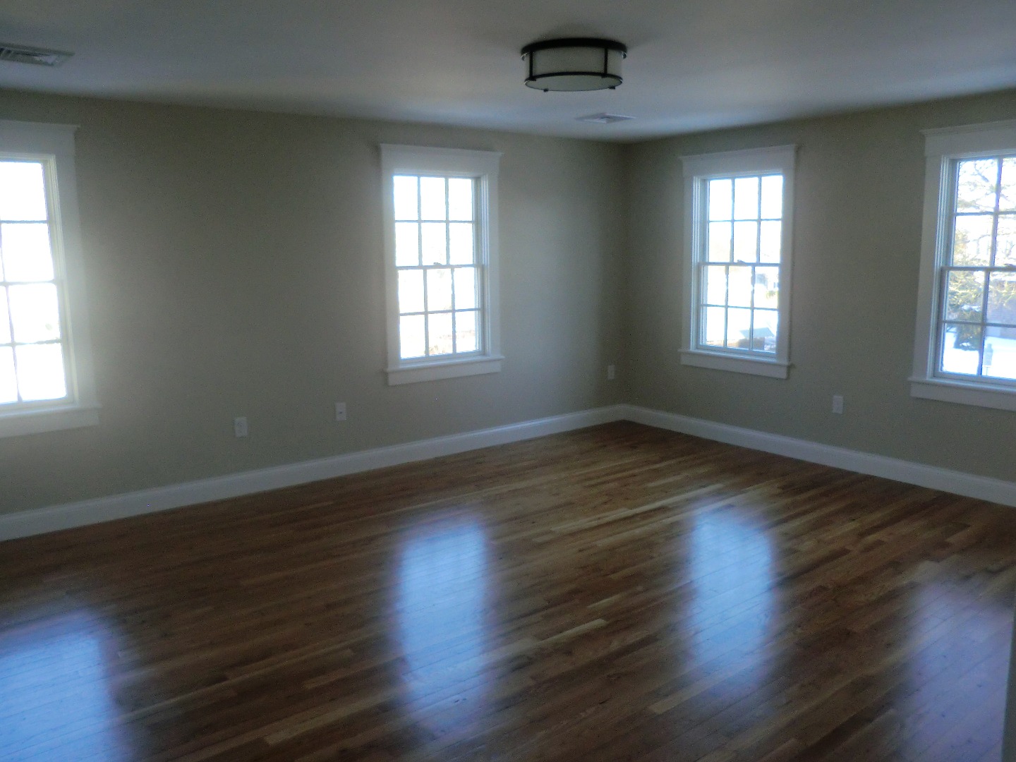 114 South Summer Street Edgartown, MA 02539 - Photo 43 of 102 an empty room with wooden floor and windows