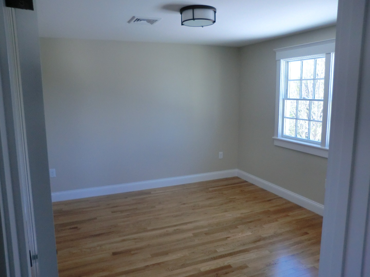 114 South Summer Street Edgartown, MA 02539 - Photo 47 of 102 an empty room with wooden floor and windows