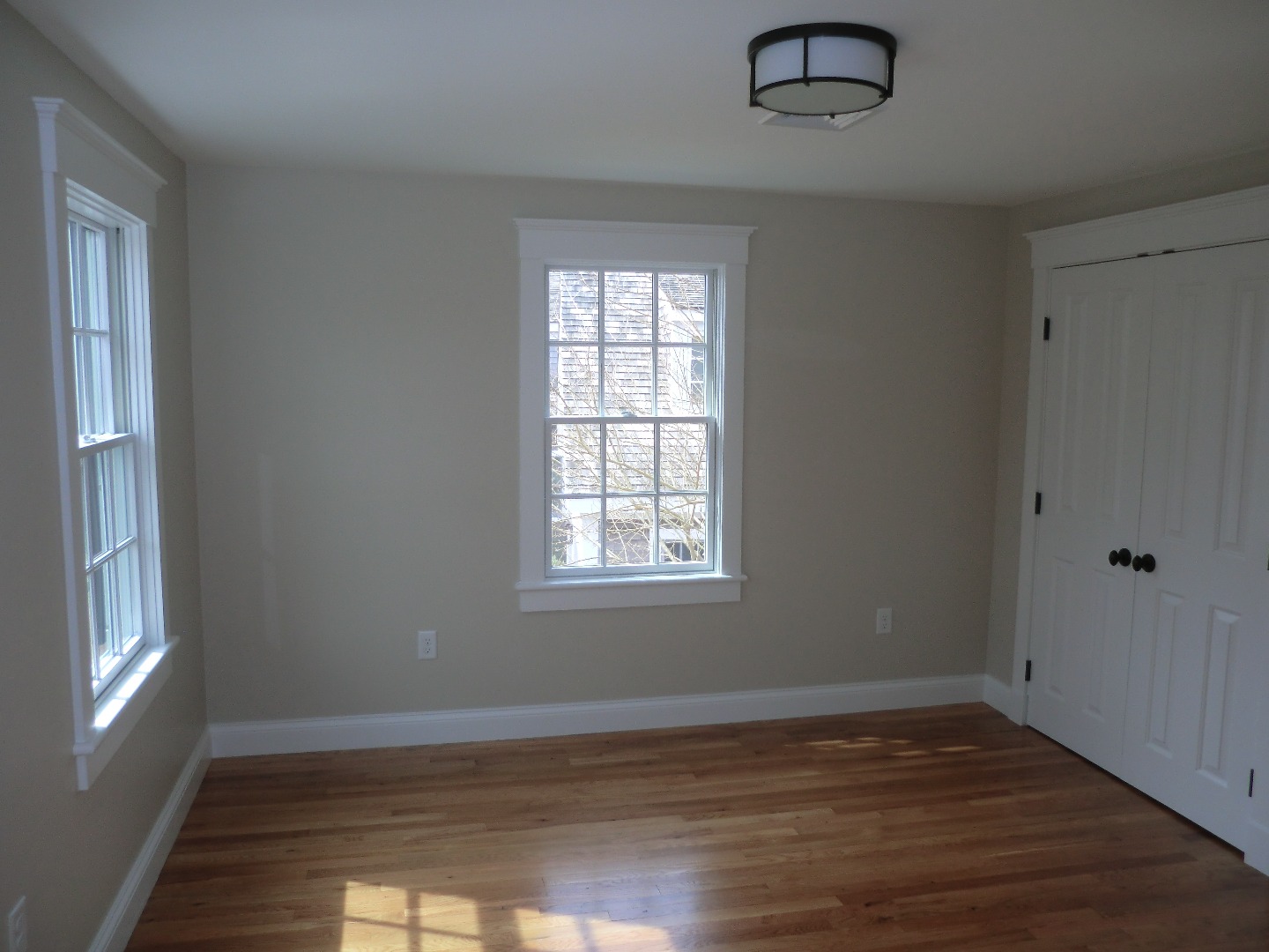 114 South Summer Street Edgartown, MA 02539 - Photo 48 of 102 a view of an empty room with wooden floor and a window