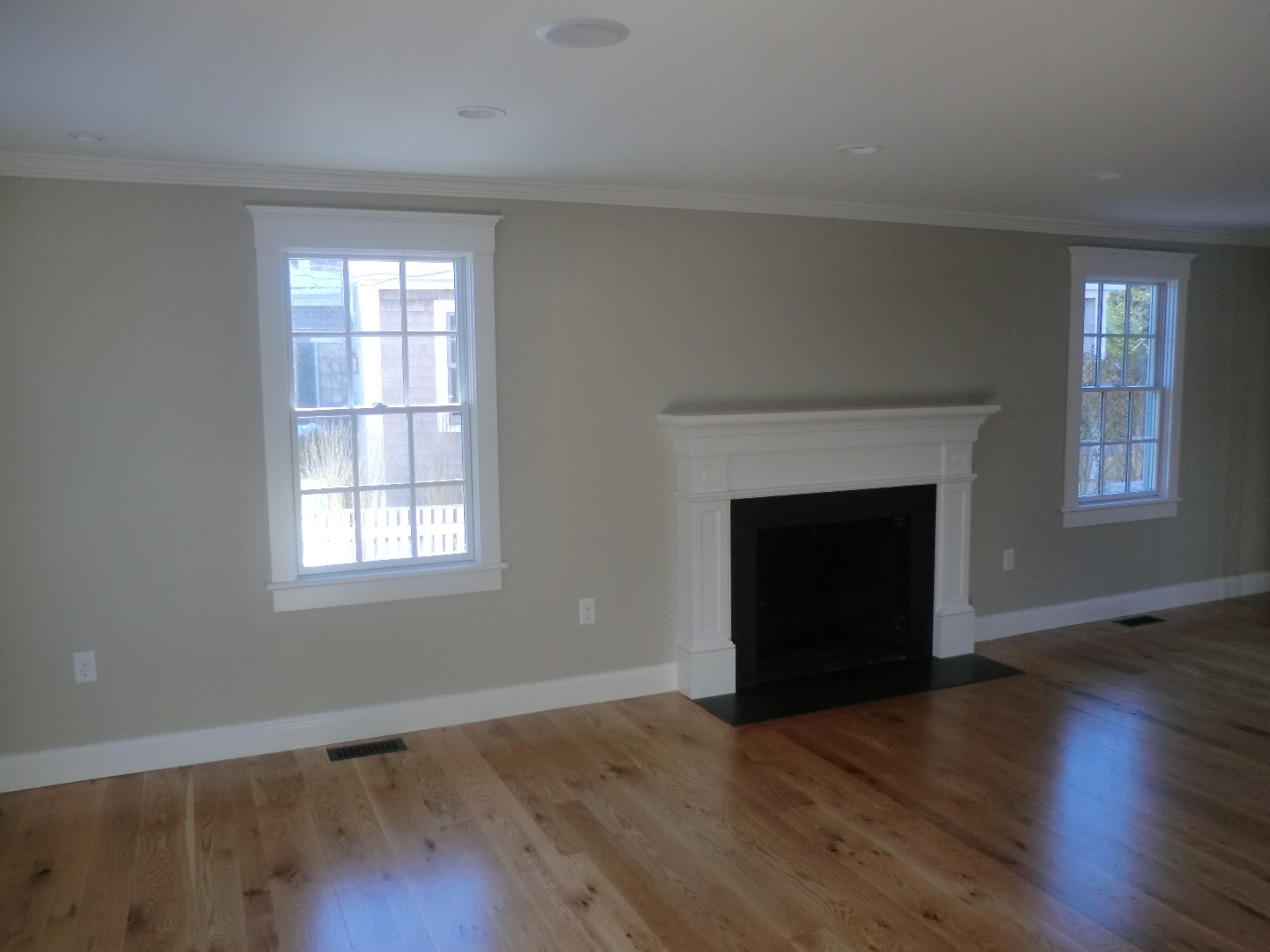 114 South Summer Street Edgartown, MA 02539 - Photo 51 of 102 an empty room with wooden floor a fireplace and windows