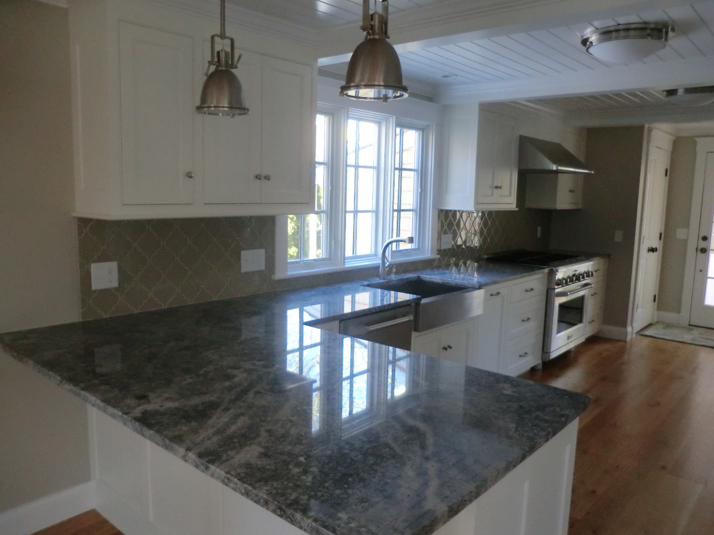 114 South Summer Street Edgartown, MA 02539 - Photo 57 of 102 a kitchen with stainless steel appliances granite countertop a sink a stove top oven a counter space and cabinets