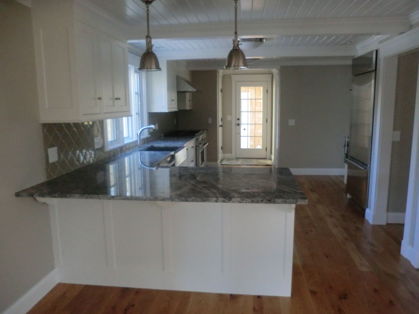 114 South Summer Street Edgartown, MA 02539 - Photo 58 of 102 a kitchen with stainless steel appliances granite countertop a sink a microwave a refrigerator and a granite counter tops
