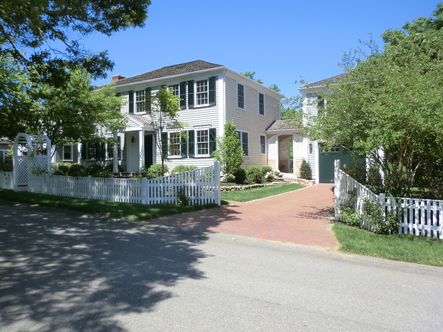 114 South Summer Street Edgartown, MA 02539 - Photo 8 of 102 a front view of a house with a yard garage and outdoor seating
