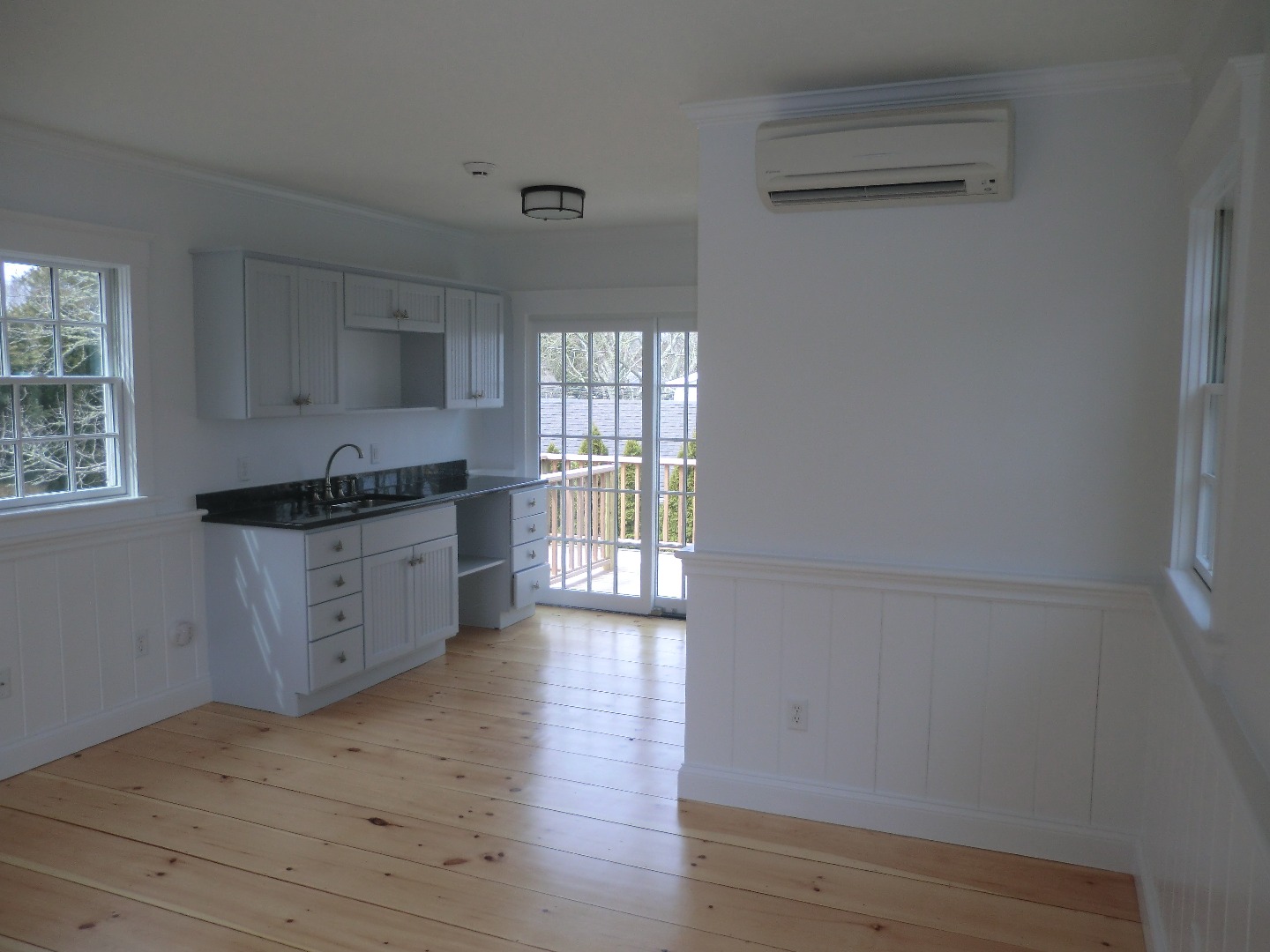 114 South Summer Street Edgartown, MA 02539 - Photo 87 of 102 a kitchen with granite countertop white cabinets and wooden floor