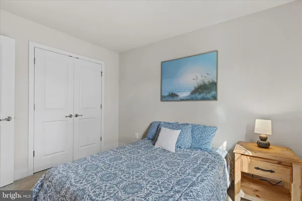 a bedroom with a bed and painting on the wall