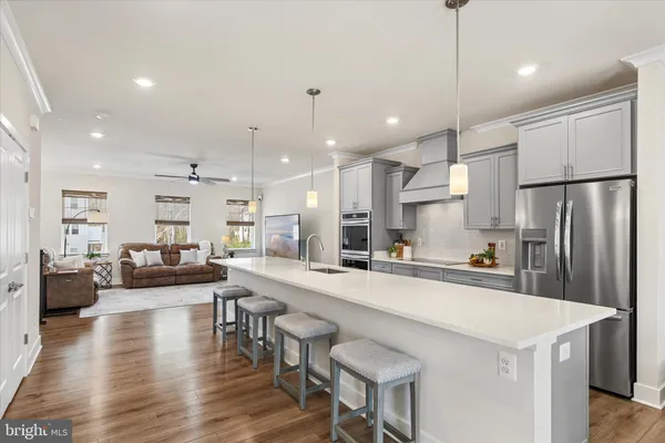 a large kitchen with a table and chairs
