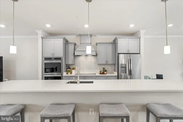 a kitchen with cabinets and chairs