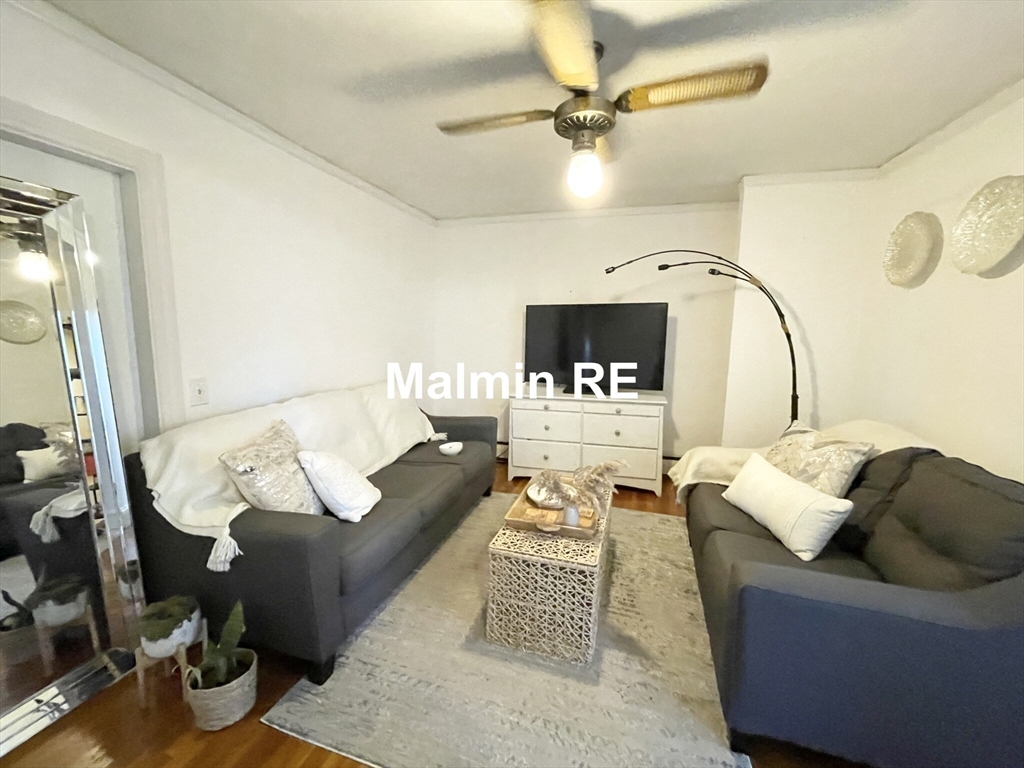 748 East 4th Street, Unit B Boston, MA 02127 - Photo 6 of 11 a living room with furniture and a fireplace