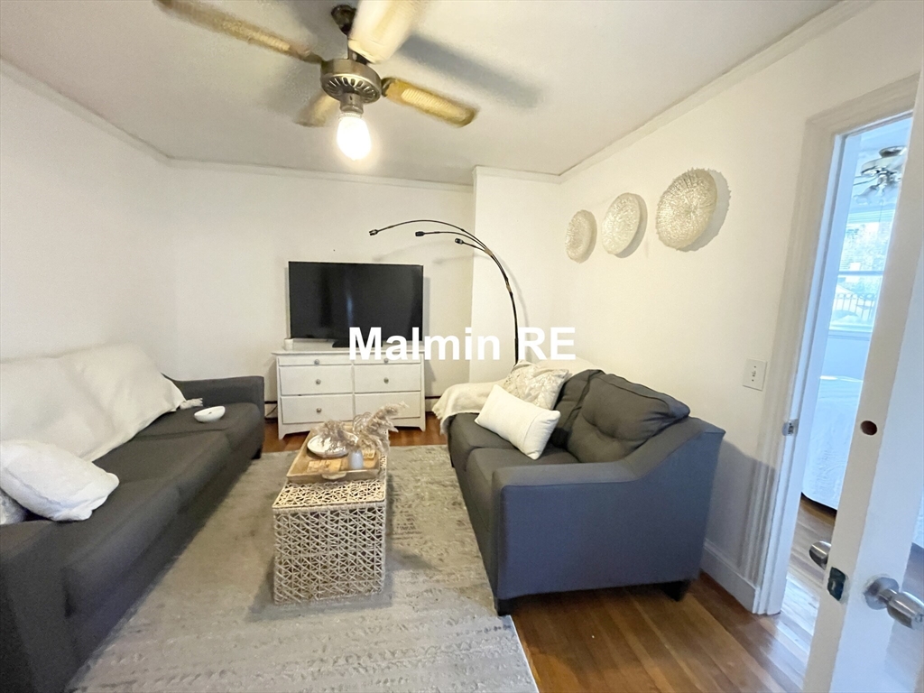 748 East 4th Street, Unit B Boston, MA 02127 - Photo 7 of 11 a living room with furniture and a fireplace
