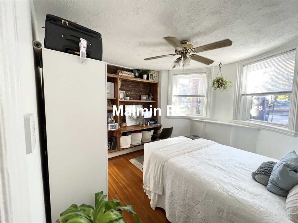 748 East 4th Street, Unit B Boston, MA 02127 - Photo 8 of 11 a bedroom with a bed dresser and a window