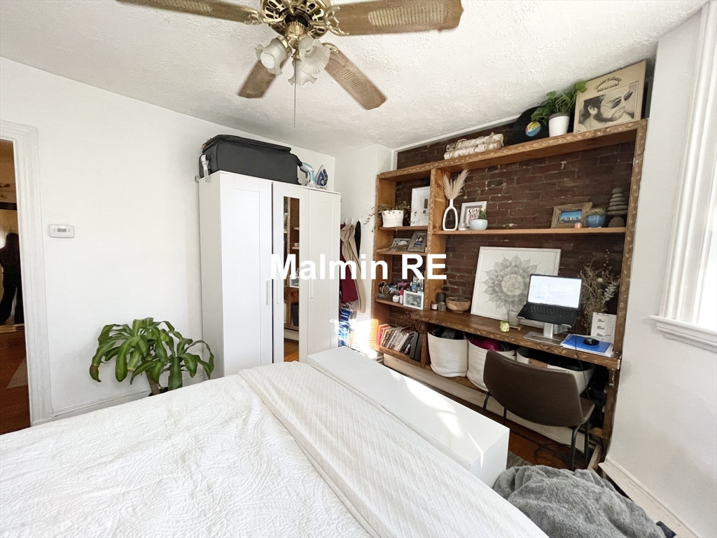748 East 4th Street, Unit B Boston, MA 02127 - Photo 10 of 11 a bedroom with a bed and a chandelier