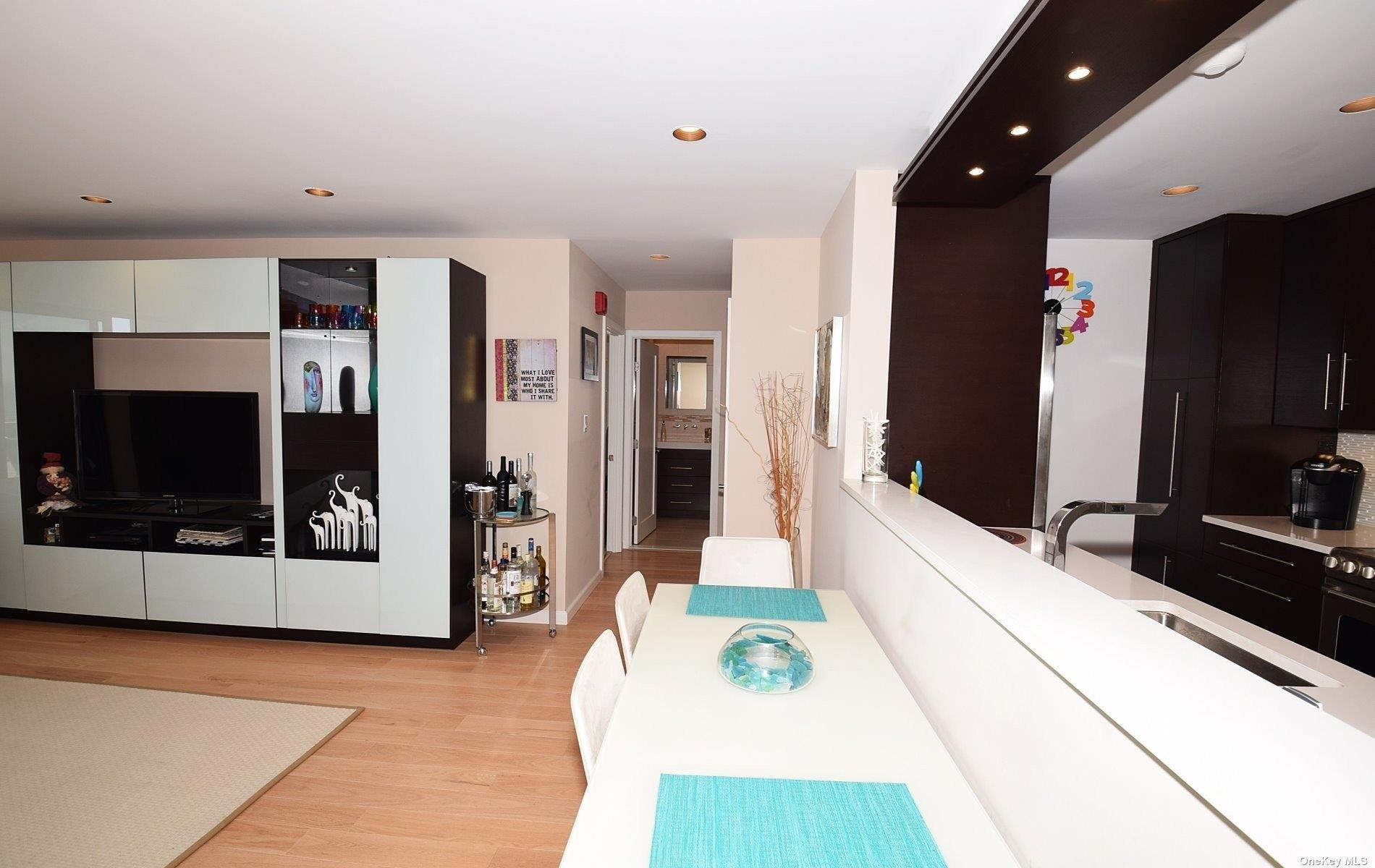 360 Shore Road, Unit 5E Long Beach, NY 11561 - Photo 12 of 21 a living room with stainless steel appliances kitchen island granite countertop furniture and a flat screen tv