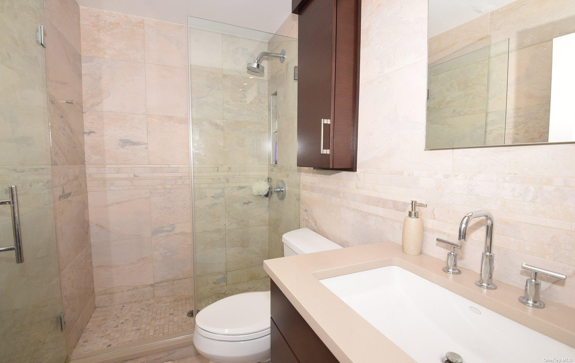 360 Shore Road, Unit 5E Long Beach, NY 11561 - Photo 15 of 21 a bathroom with a sink a toilet and shower