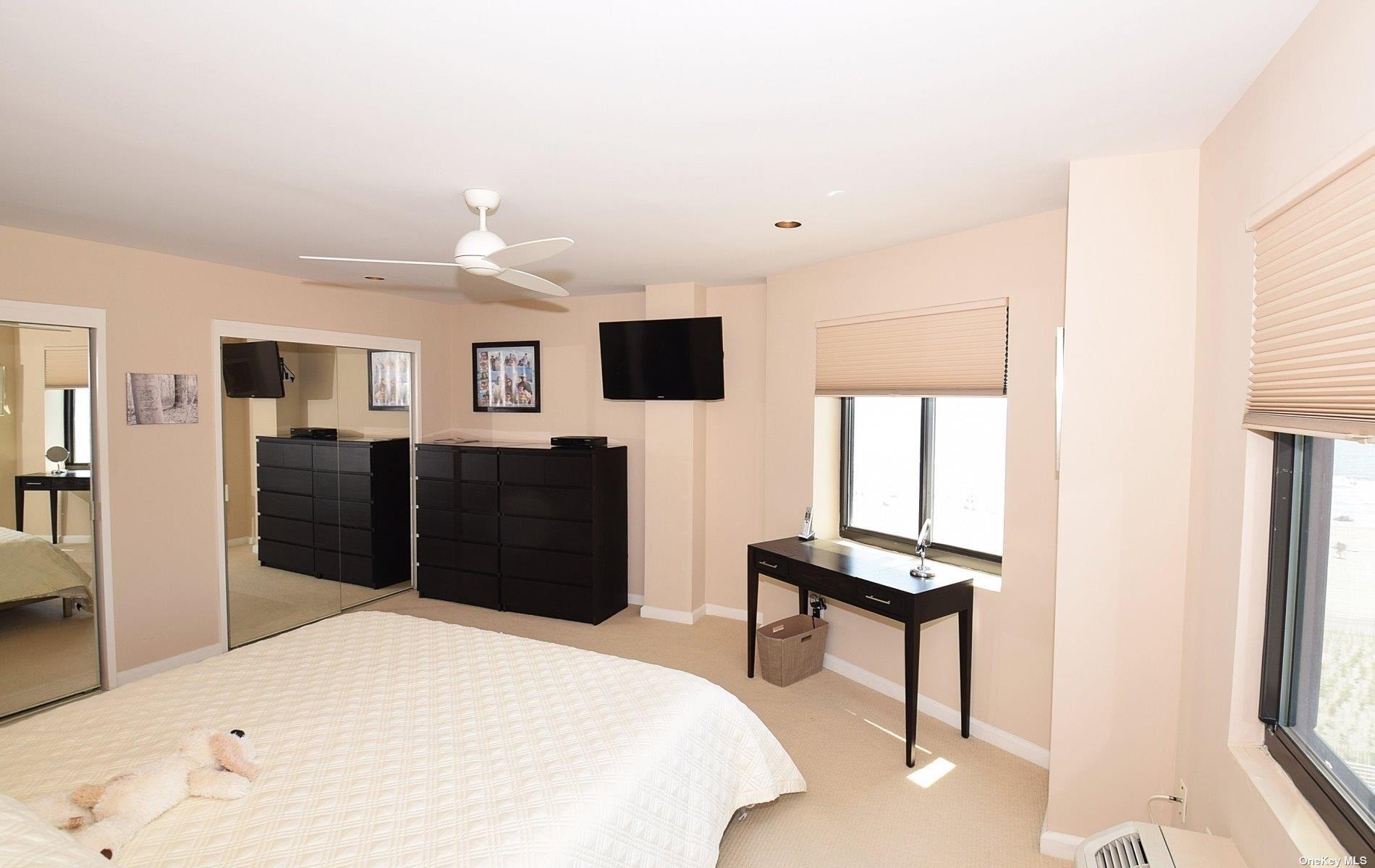 360 Shore Road, Unit 5E Long Beach, NY 11561 - Photo 16 of 21 a bedroom with a bed and a flat screen tv