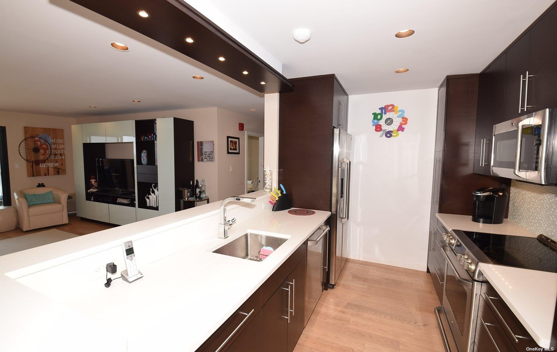 360 Shore Road, Unit 5E Long Beach, NY 11561 - Photo 6 of 21 a kitchen with granite countertop a sink stove and refrigerator