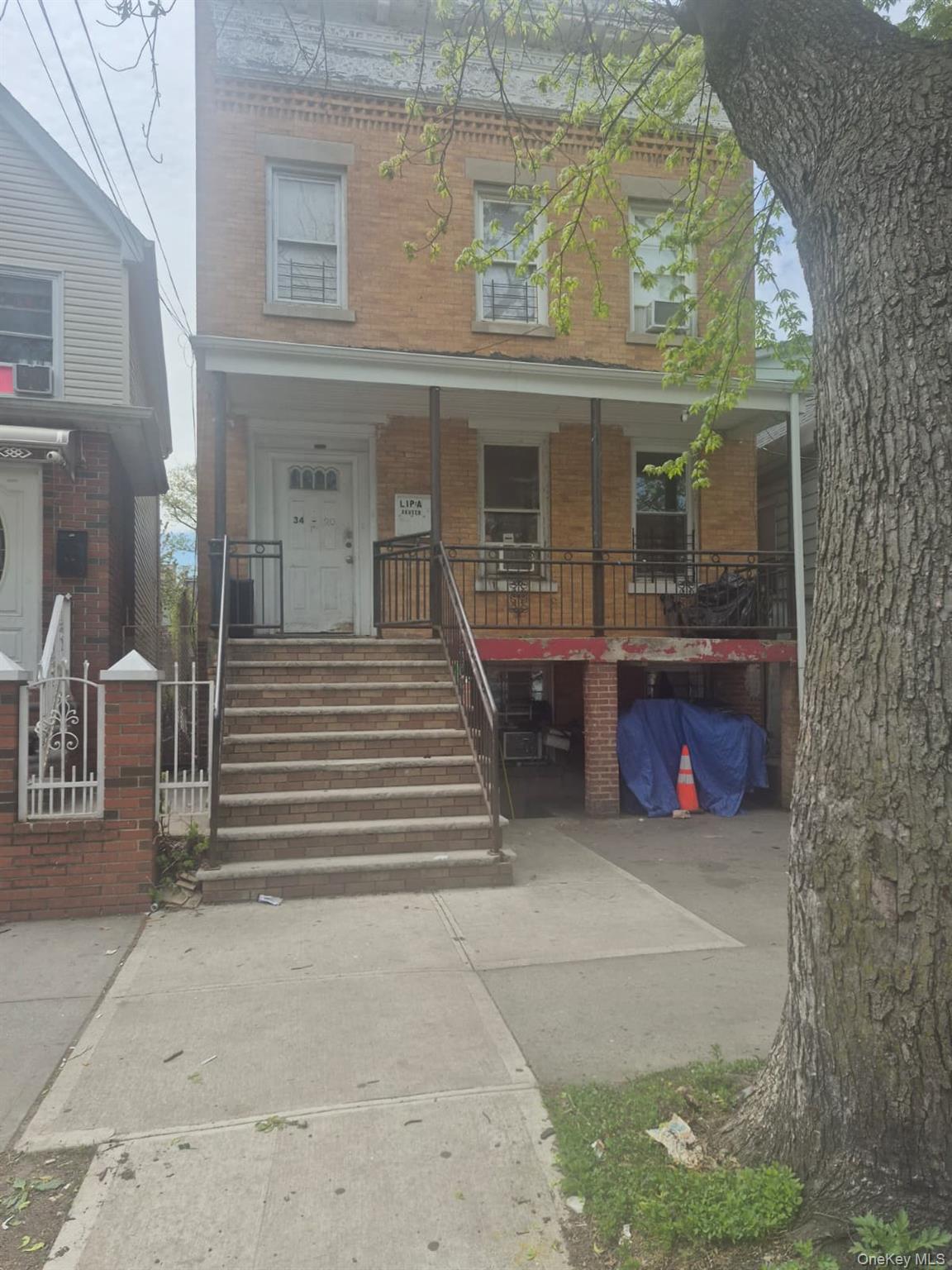 34-20 100th Street Queens, NY 11368 - Photo 2 of 4 a view of a house with entrance gate