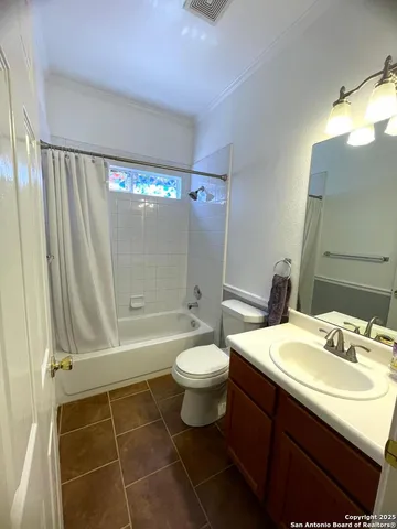 a bathroom with a sink a toilet a mirror and shower