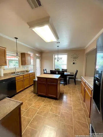 a large kitchen with a counter space cabinets and appliances