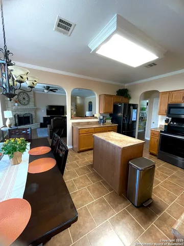 a large living room with stainless steel appliances kitchen island granite countertop a large kitchen counter top and stainless steel appliances