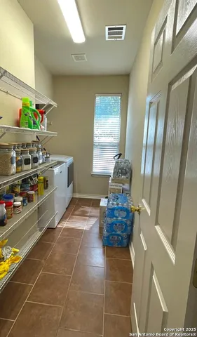 a room with a table chairs and a stove