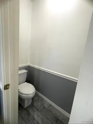 a white toilet sitting next to a shower