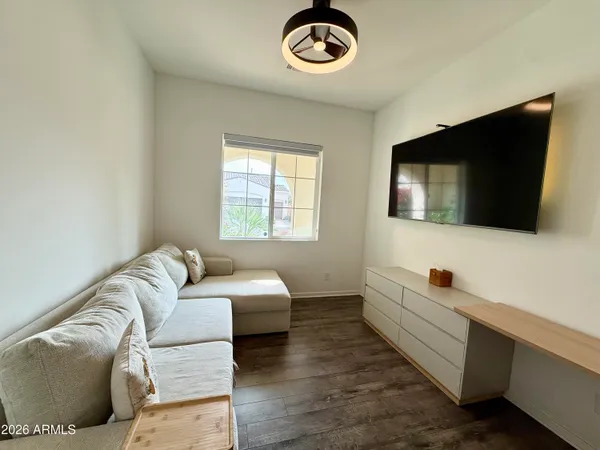 a living room with couches and a flat screen tv